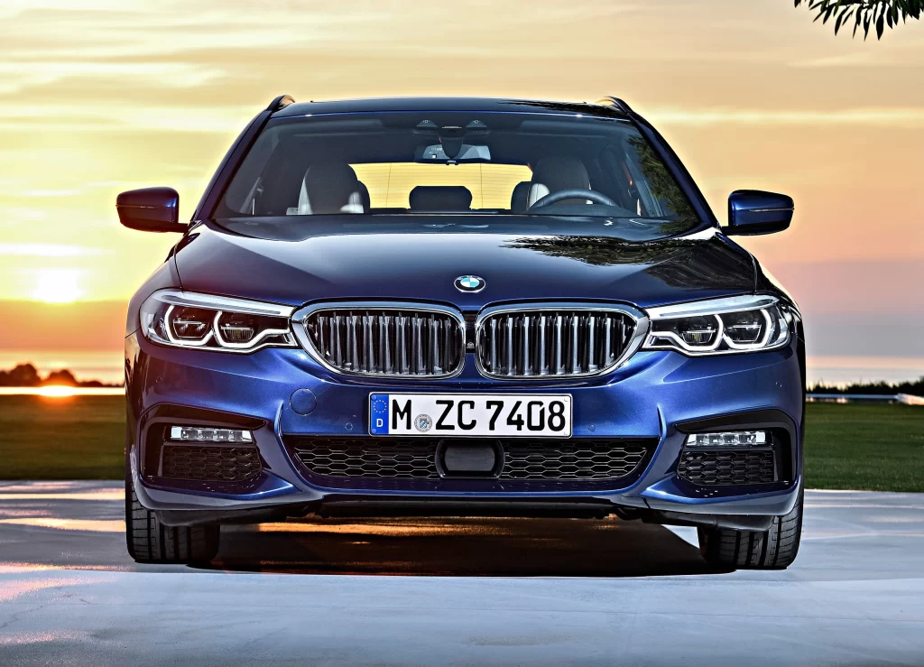 Blue BMW Sedan Sunset Front View