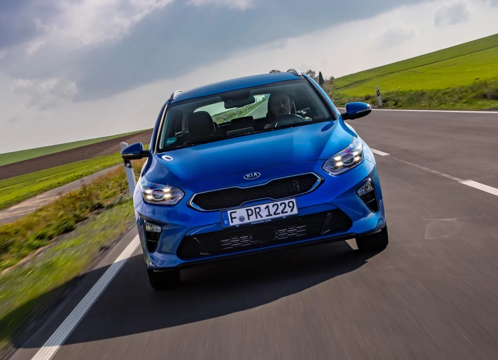 Blue Kia Hatchback Road View