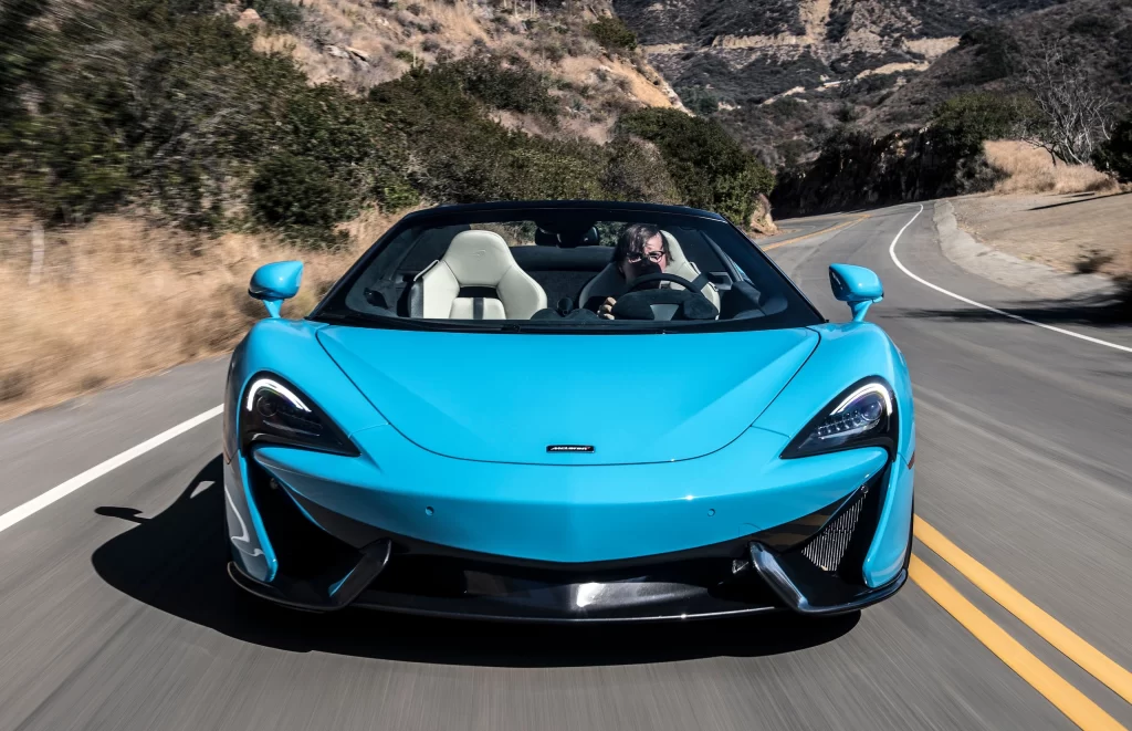 Blue McLaren Sports Car Road Front View