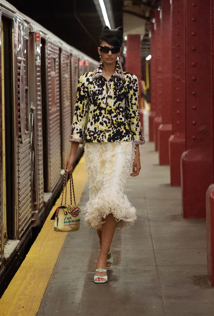 Chanel Metiers d’Art 2026 Look 67 Jacket and Skirt Black and Yellow Runway Photography