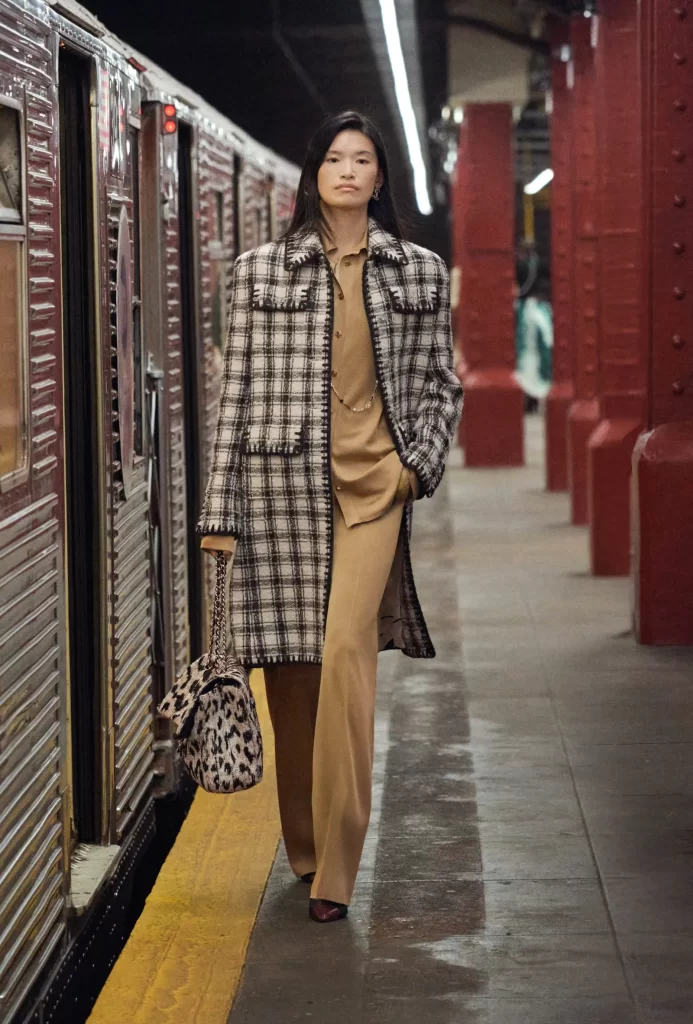 Chanel Metiers d’Art 2026 Look 44 Tweed Jacket and Trousers Black and White Runway Photography