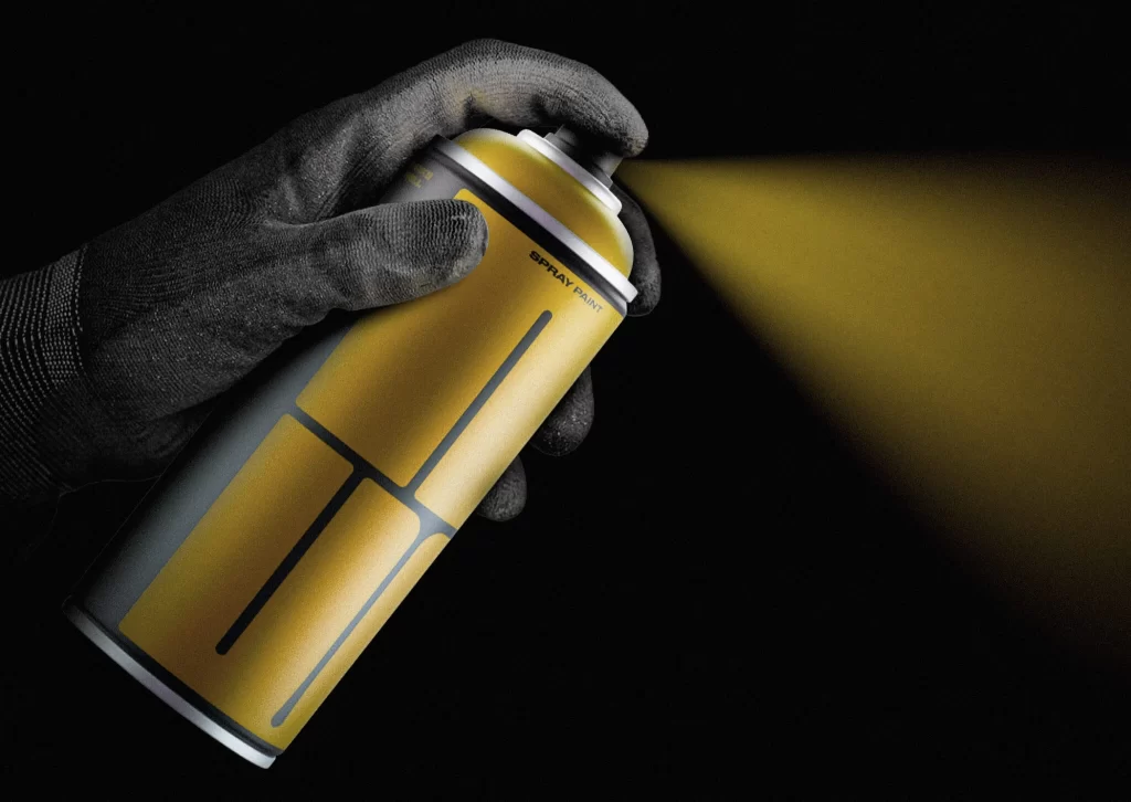 Hand Spraying Yellow Paint Can