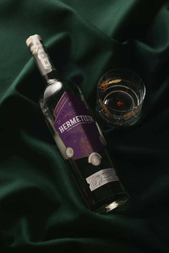 Hermetista Gin Bottle Green Backdrop View