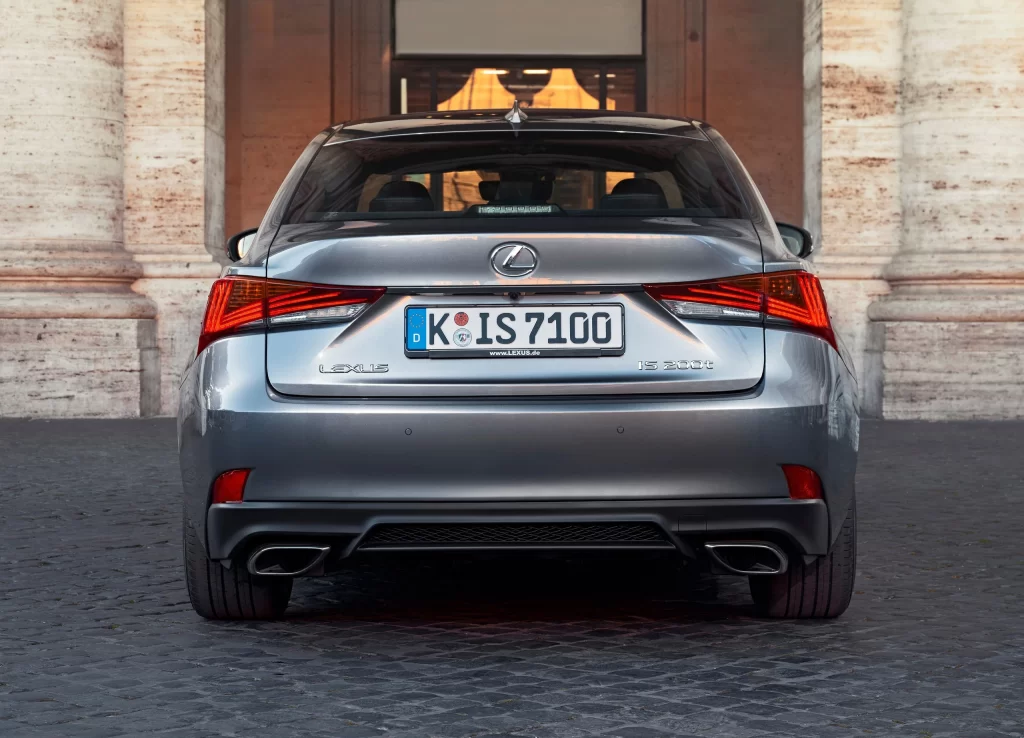 Silver Sedan Cobblestone Street Rear View