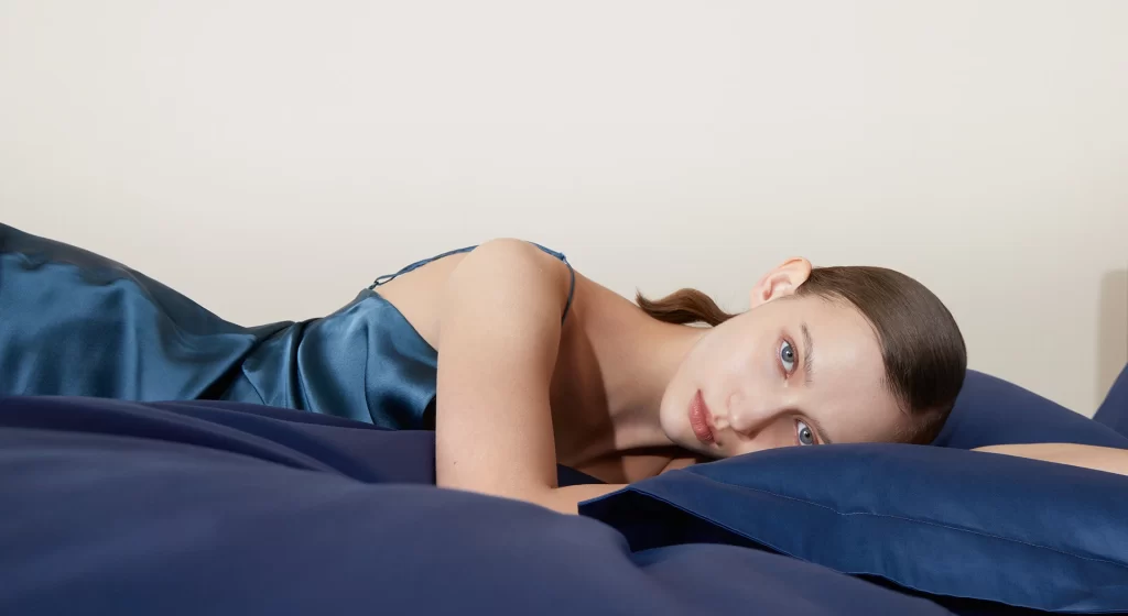 Woman Blue Satin Dress On Bed