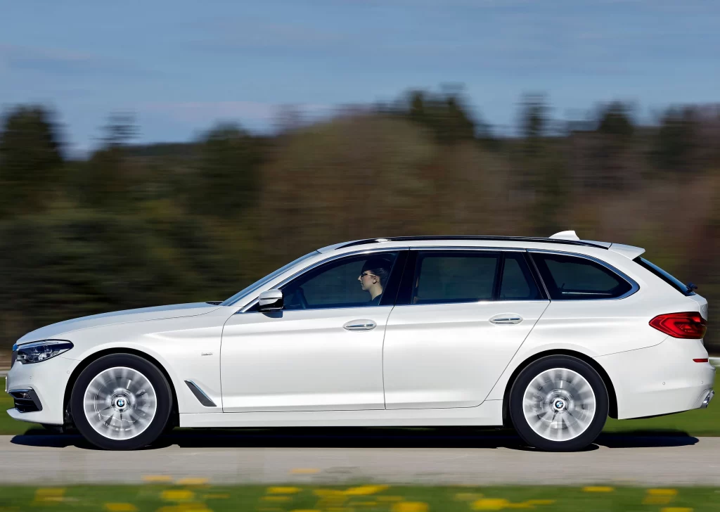 White BMW Wagon Scenic Road Side View