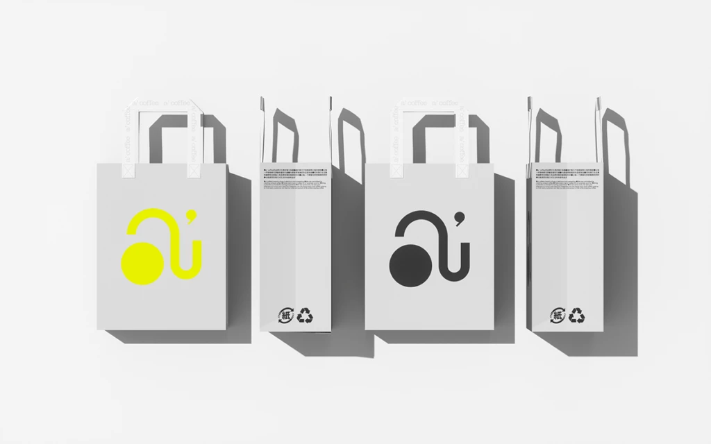 White Paper Bags With Black And Yellow Logos Bag