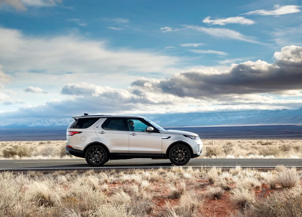 White SUV Arid Desert Road Driving View