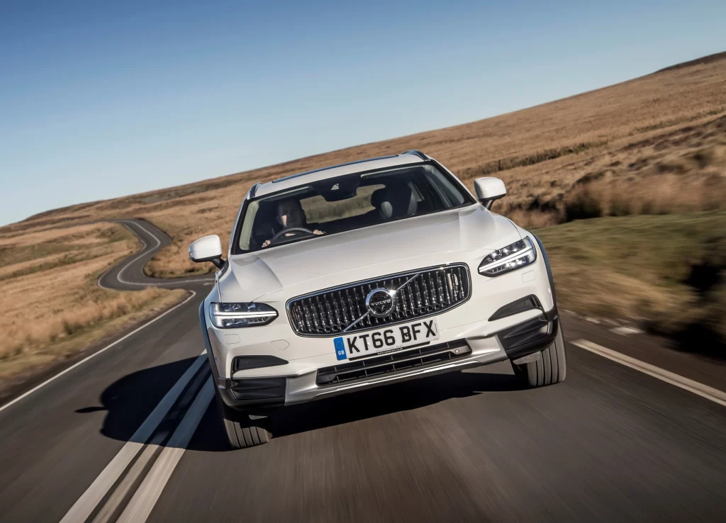 White Volvo SUV Rural Road Front View