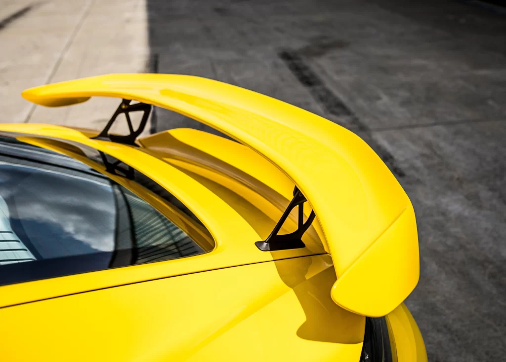 Yellow Sports Car Rear Wing Parked View