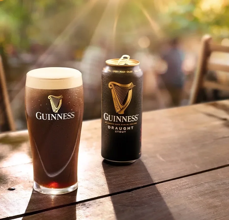 Guinness Draught Stout Can And Glass Wooden Table